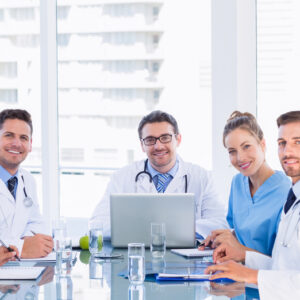 Portrait of a smiling medical team around desk in the office